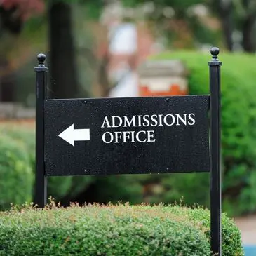 Here's an alt tag for the image: `Admissions Office sign, left arrow`