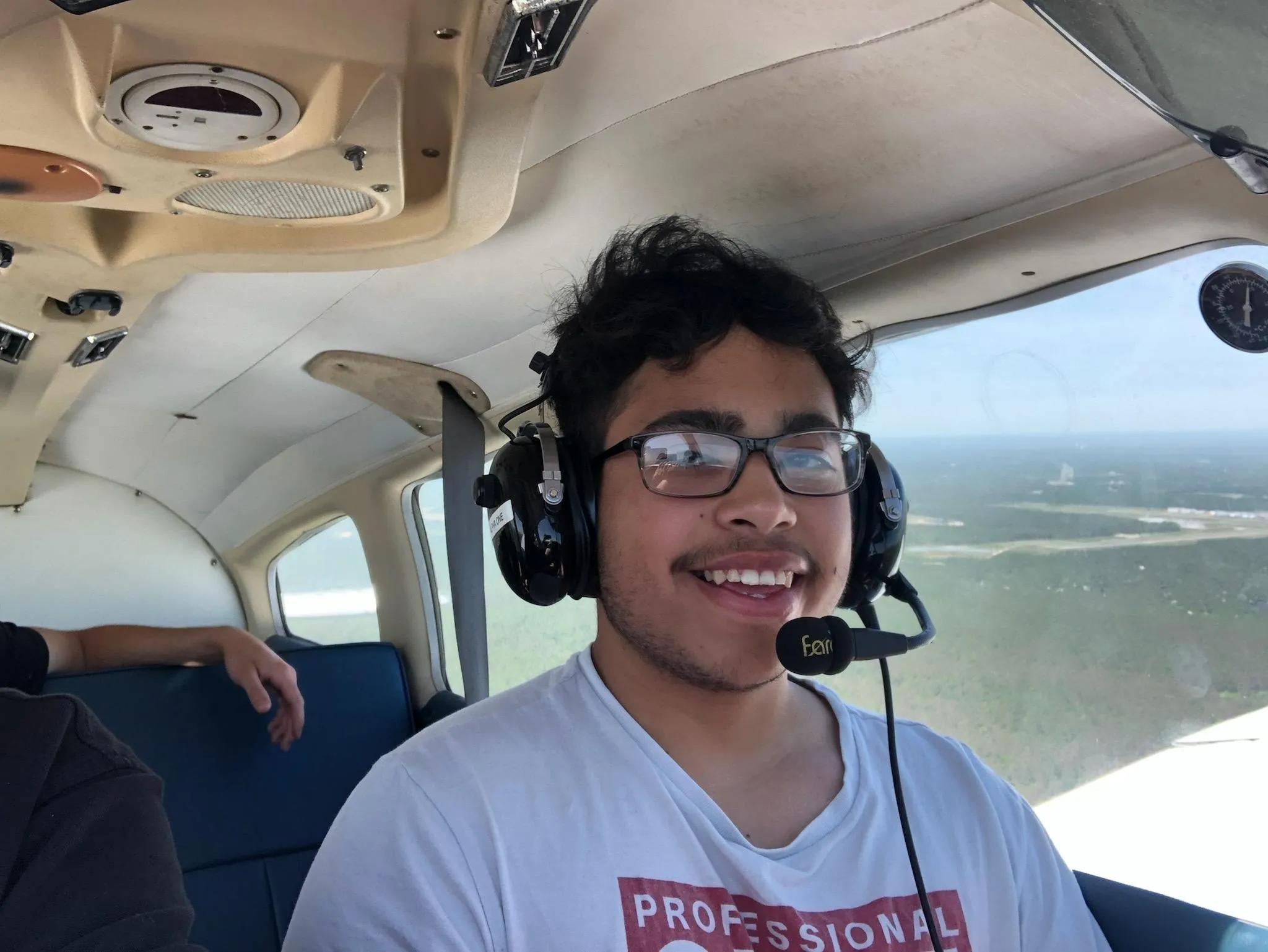 Smiling teen in airplane headset.