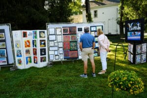 A man and woman looking at art on display.