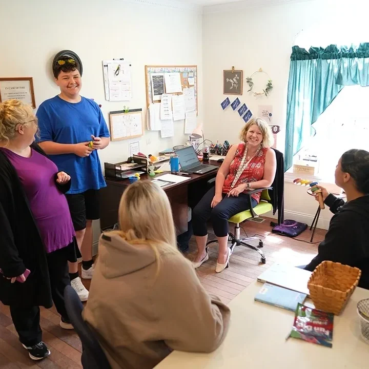 Group therapy session in a bright room.