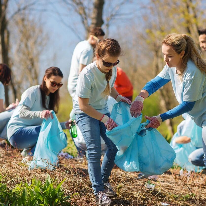 Volunteers cleaning up park trash.